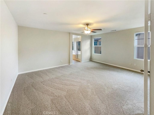 empty room with light colored carpet and ceiling fan