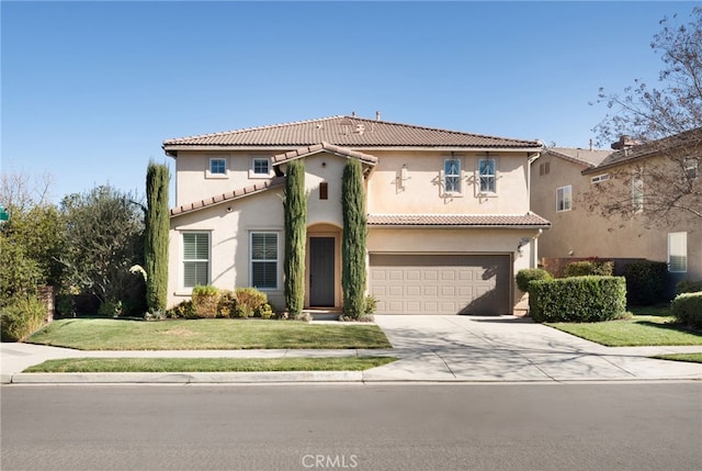 mediterranean / spanish house with a front yard and a garage