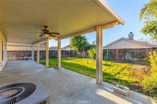 view of patio with a playground, ceiling fan, and central AC unit