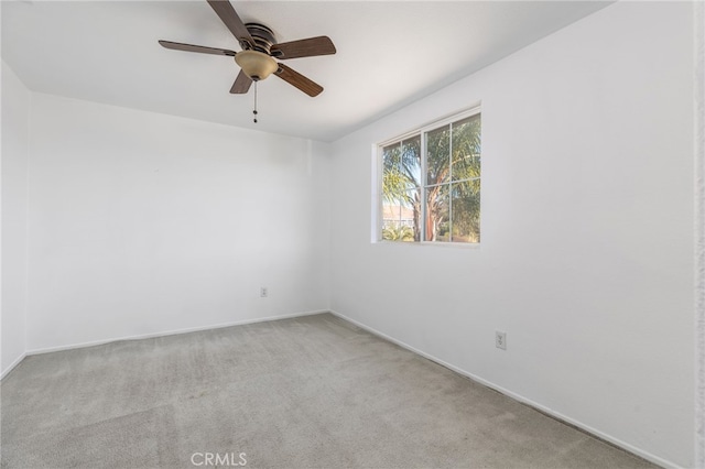 unfurnished room featuring ceiling fan and light colored carpet