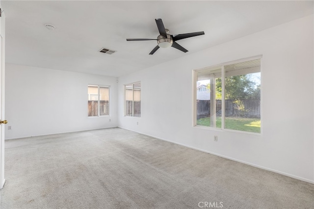 unfurnished room featuring light colored carpet and ceiling fan