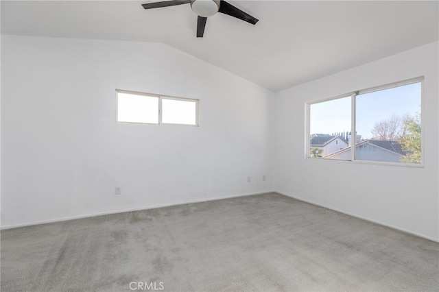 empty room featuring ceiling fan, light colored carpet, and lofted ceiling