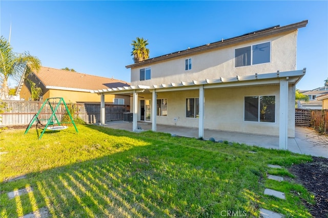 rear view of house featuring a patio, cooling unit, a playground, and a lawn