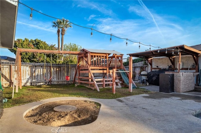 view of jungle gym with exterior kitchen, a patio area, and a yard