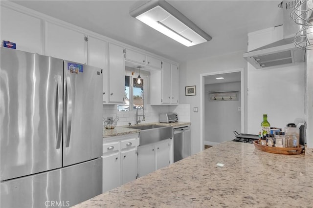 kitchen with appliances with stainless steel finishes, white cabinetry, decorative light fixtures, and sink