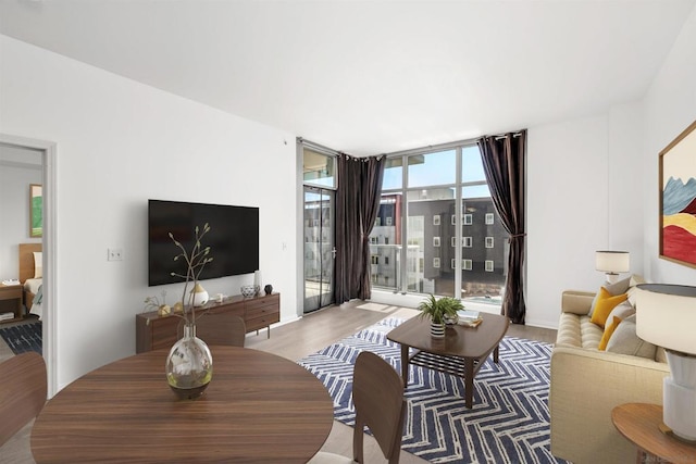 living room featuring a wall of windows and wood-type flooring