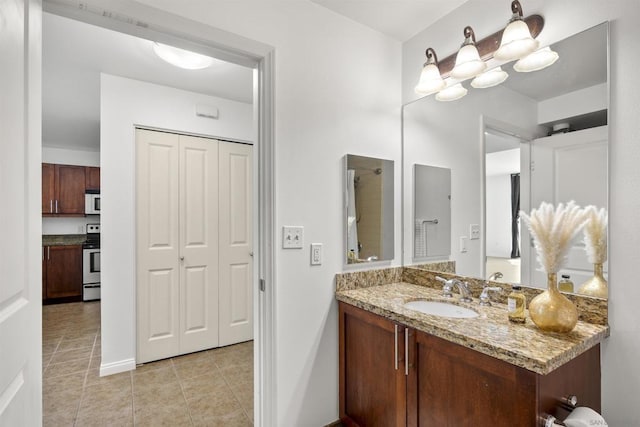 bathroom with tile patterned floors, vanity, and a shower