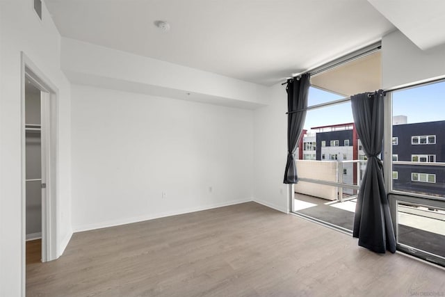 unfurnished room featuring hardwood / wood-style flooring