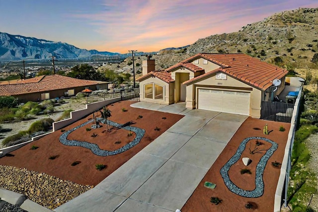 view of front of home featuring a garage and a mountain view