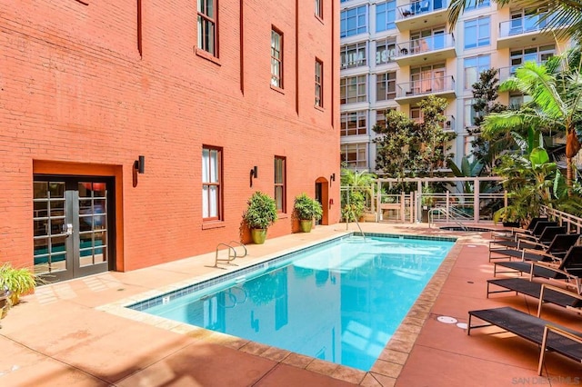 view of swimming pool featuring french doors