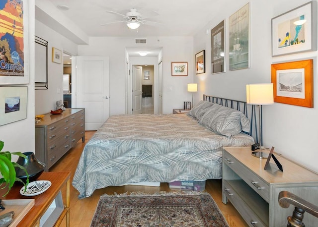 bedroom with ceiling fan and light hardwood / wood-style floors