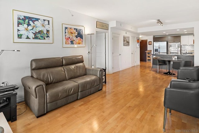 living room featuring light hardwood / wood-style flooring and sink