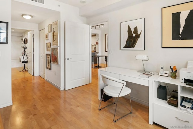 office space with light hardwood / wood-style flooring