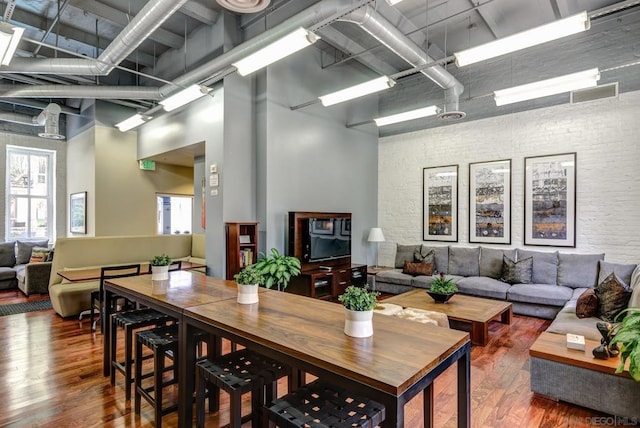 dining area with a high ceiling and hardwood / wood-style flooring