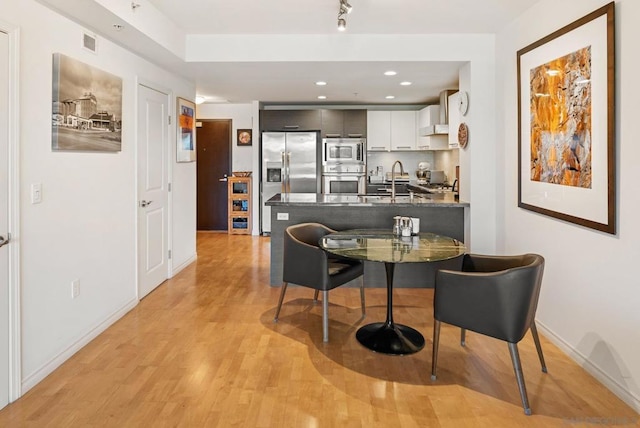 interior space with sink and light hardwood / wood-style floors