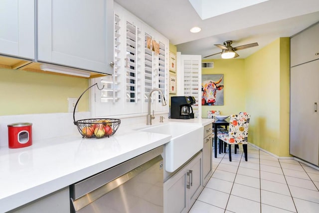 kitchen featuring ceiling fan, dishwasher, light tile patterned floors, and sink