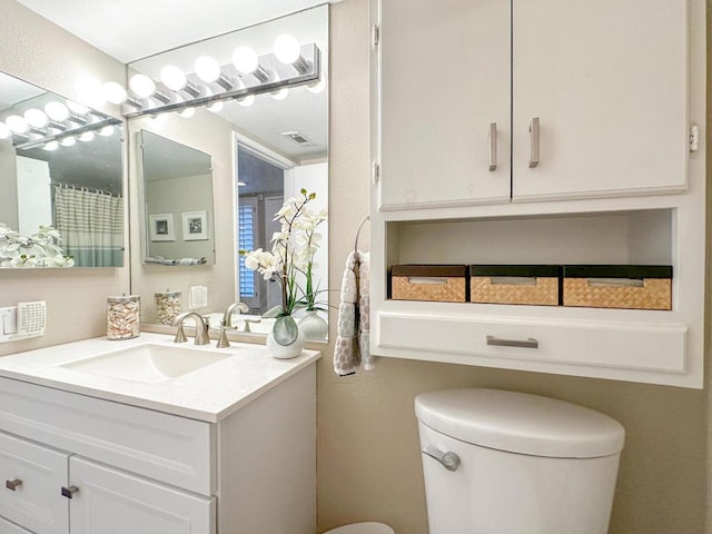 bathroom featuring vanity and toilet