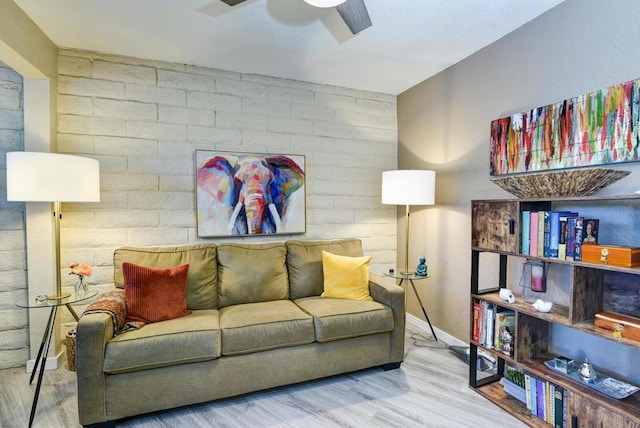 living area with ceiling fan and hardwood / wood-style flooring