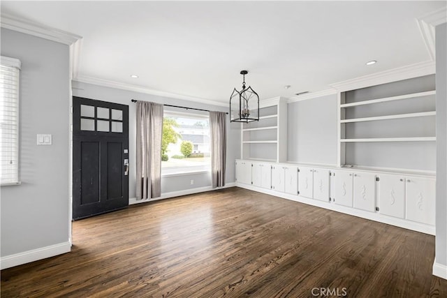 unfurnished dining area with ornamental molding, dark hardwood / wood-style flooring, and a chandelier