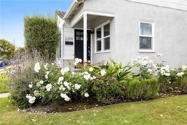 entrance to property with a lawn