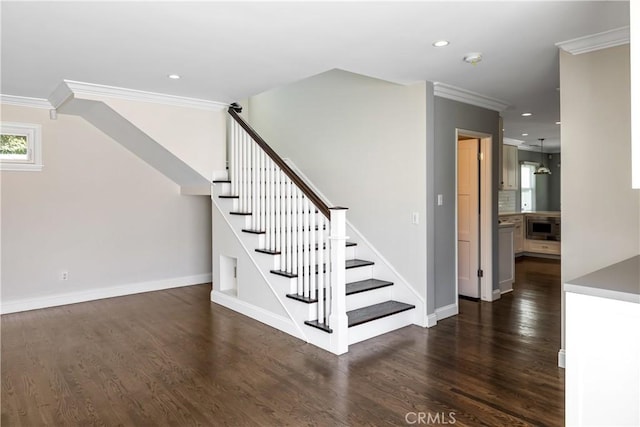 stairway with crown molding and wood-type flooring