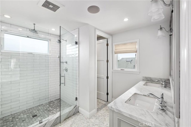 bathroom featuring an enclosed shower, vanity, tile patterned floors, and a healthy amount of sunlight