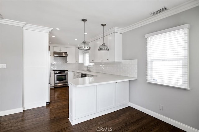 kitchen featuring kitchen peninsula, hanging light fixtures, stainless steel range oven, white cabinets, and ornamental molding