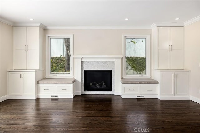 unfurnished living room featuring dark wood-type flooring and crown molding