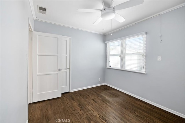 spare room featuring ornamental molding, ceiling fan, and dark hardwood / wood-style flooring