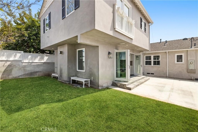 back of house featuring a balcony, a yard, and a patio