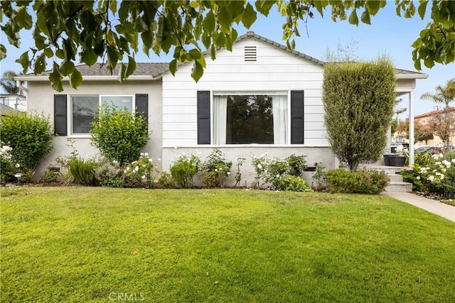 view of side of property with a lawn