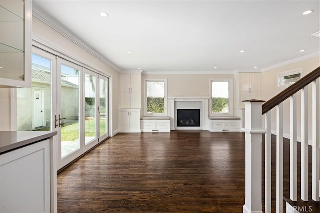 unfurnished living room featuring ornamental molding, french doors, and dark hardwood / wood-style floors