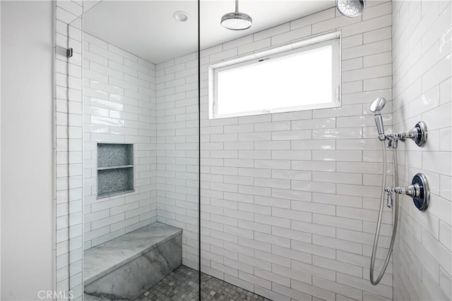 bathroom featuring tiled shower