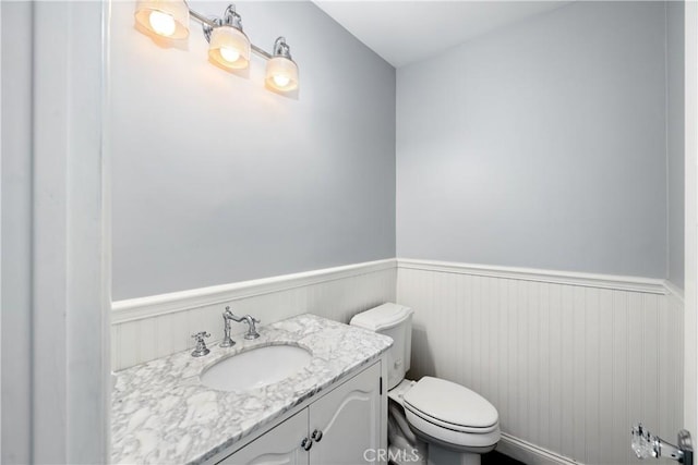 bathroom featuring toilet and vanity