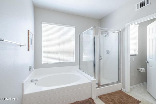 bathroom with separate shower and tub