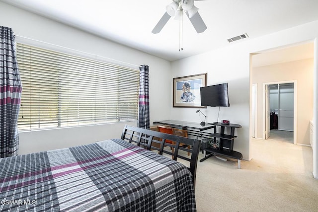 carpeted bedroom with a closet and ceiling fan