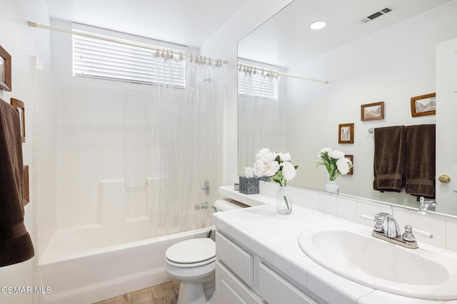 full bathroom with shower / bathing tub combination, vanity, toilet, and a healthy amount of sunlight