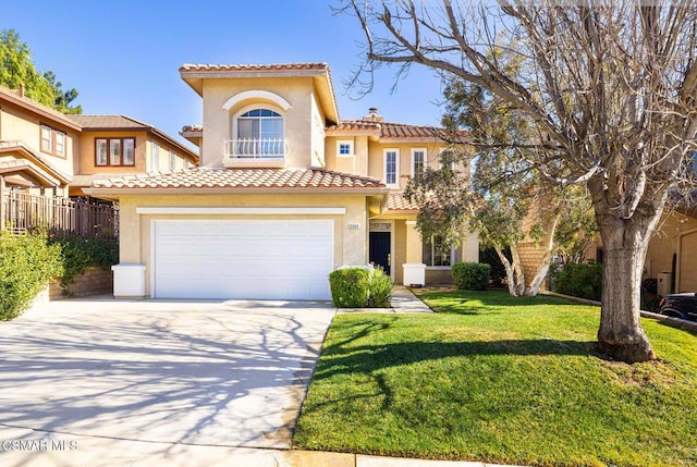 mediterranean / spanish-style home with a garage and a front lawn