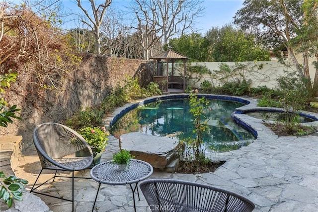 view of swimming pool with a patio area and a gazebo