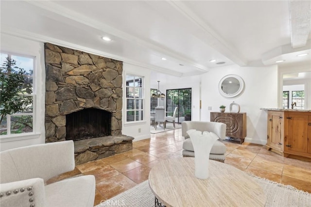 living room featuring light tile patterned floors, a fireplace, and beamed ceiling