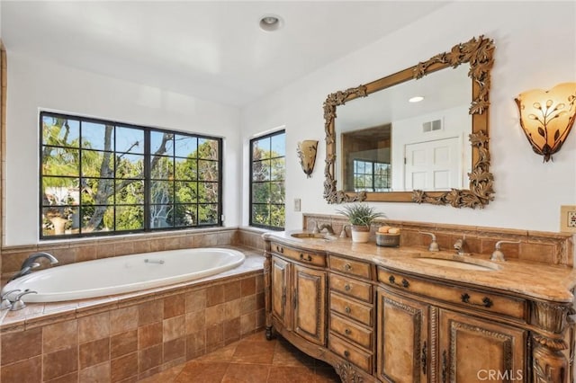 bathroom with vanity, tile patterned flooring, and a relaxing tiled tub