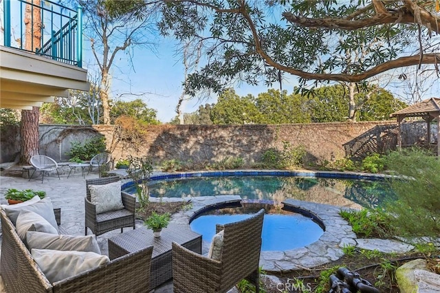 view of pool with a patio and an in ground hot tub