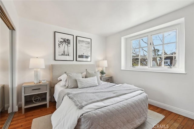 bedroom with a closet and hardwood / wood-style flooring