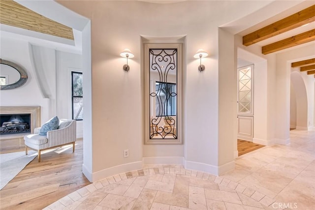 hallway featuring beamed ceiling