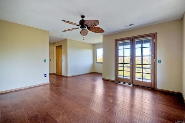 unfurnished room with dark hardwood / wood-style floors, ceiling fan, and french doors