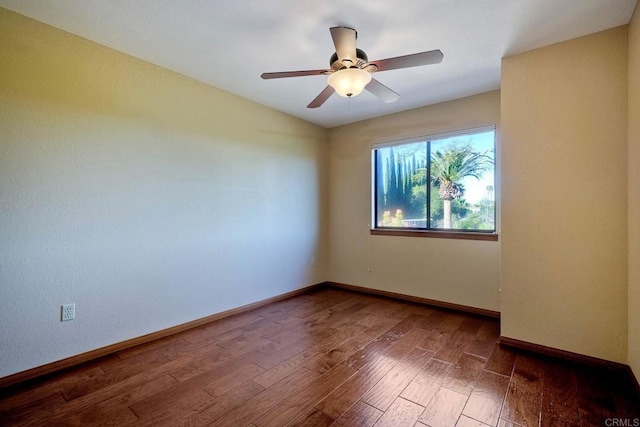 unfurnished room with dark wood-type flooring and ceiling fan