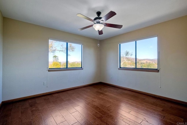 empty room with hardwood / wood-style flooring and ceiling fan