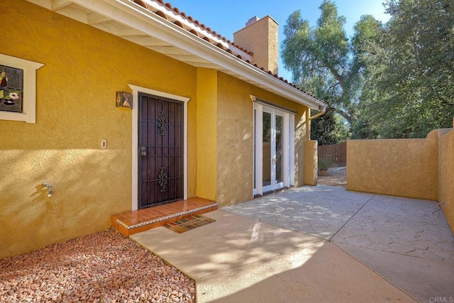 property entrance featuring a patio area