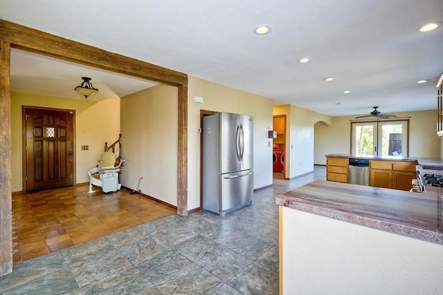 kitchen with ceiling fan, stainless steel appliances, and kitchen peninsula