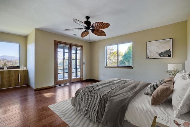 bedroom with dark wood-type flooring, access to exterior, ceiling fan, and french doors